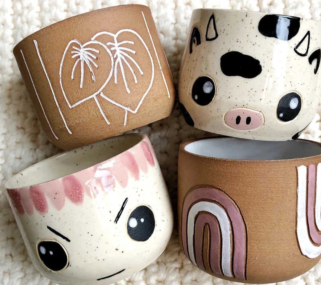 Stacked Handcrafted Ceramic Mugs with Earthy Designs