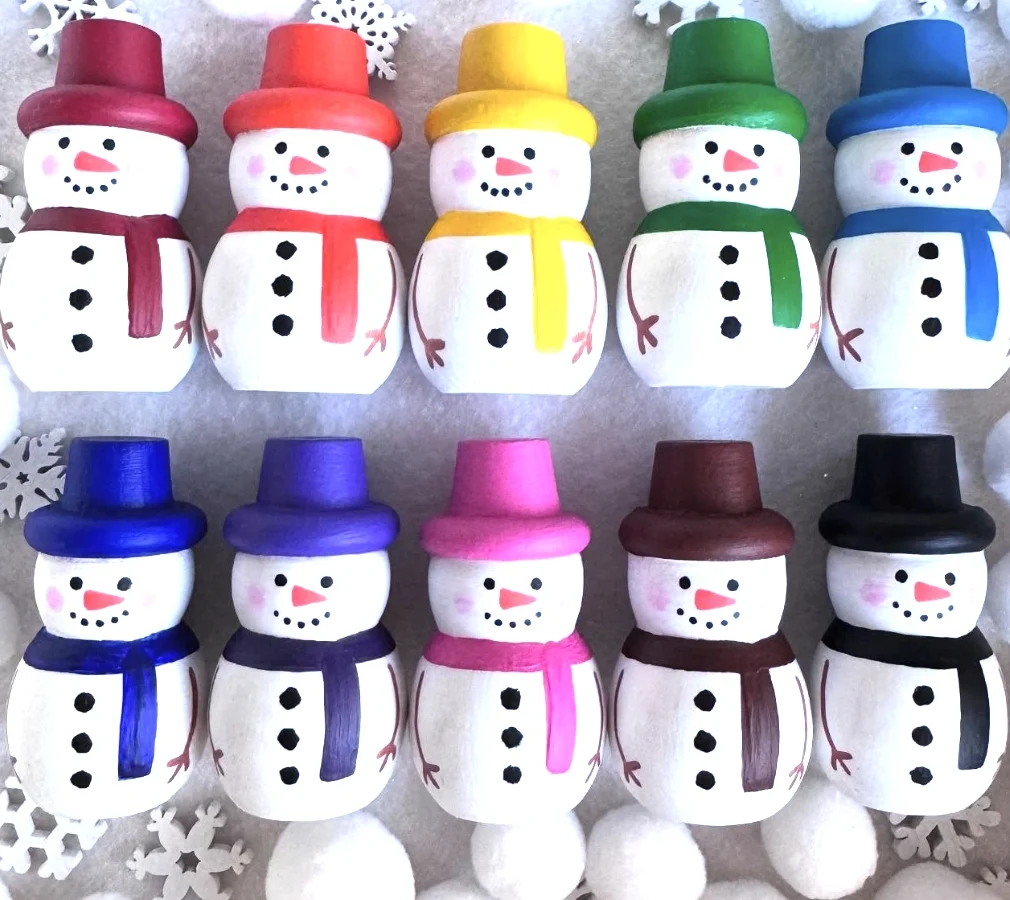 Row of Hand-Painted Wooden Snowmen with Colorful Hats and Scarves