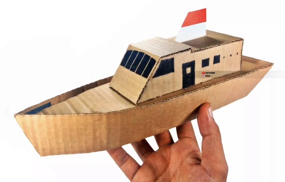 Miniature Cardboard Boat Model with White and Red Flag